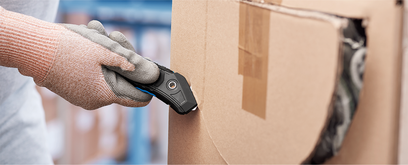 Using a concealed blade cutter to cut through cardboard